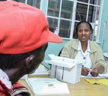 A health worker speaks and gives medication to a patient.  Kenya has embarked on a extensive evidence-based approach to root out TB 