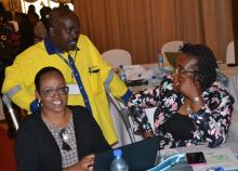 Dr Iheoma Onuekwusi, right, WHO EPI head consults with Immunization ambassador Mr Hillary Kipchumba and partner Amina Mungai, American Red Cross during the event