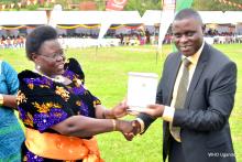 Dr Kaggwa (right) receives the newly launched National TB and Leprosy Program Agenda for Operations and Implementation Research 2018-2022 from Dr Moriku Joyce on behalf of WHO