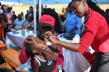 A nurse giving vaccine to a child