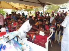 A health worker providing vaccine to a child