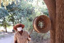              Muchaneta Samu ringing the bell, a signal for the community to come to the gathering spot