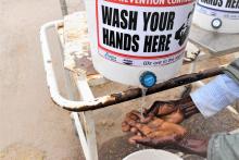 Patient washing their hands before they enter the hospital premises 