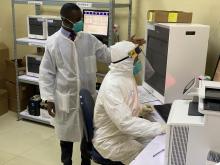 Health workers at Mutukula Port Health Laboratory explains sample handling and testing at the COVID-19 laboratory