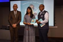 An expectant mother receiving a copy of the MCH Handbook from Dr L Musango, WHO Representative in Mauritius, in the presence of  Dr Hon k. K. Jagutpal, Minister of Health and Wellness