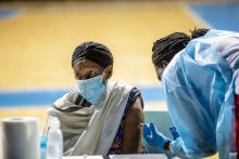 An elder woman receiving her 1st dose of COVID-19 Vaccine