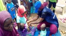 Medical Intervention at Falu IDP camp in Adamawa State (The nutrition status of a child that received immunization is being evaluated with the MUAC tape)