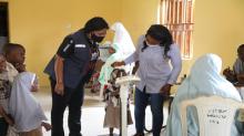 Aisha Yau and two of her children receiving medical consultation