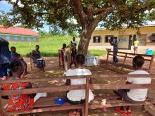 Children receiving vaccines under a tree in the hard-to-reach Nadiangere village in South Sudan