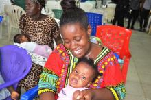 A happy mother affords a smile after her daughters vaccinatio- recognising the importance of protecting her daughter from vaccine-preventable diseases.