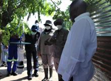 Dr Sagoe-Moses and Hon. Wakudumo observing one of the malaria control activities at one of the homestead 