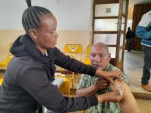 A community leader in Manyara Region receiving COVID-19 vaccine after the sensitization meeting