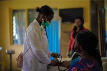 A health worker checking blood pressure