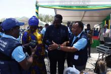 WHO staff, Dr. William Mwengee and Mr. Hashim Mahige showing some of the donated items to the Guest of Honor