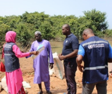 Health workers about to enter a canoe to Ruggar Budo