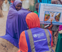 A community health champion providing interpersonal health risk messaging on cholera prevention.jpg