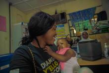 A caregiver Mrs Lawrence at the Kuje vaccination centre with her baby