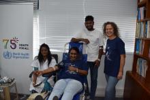 Shamila Ajodha, Programme Assistant, WHO Mauritius donating blood with her son and Dr Ancia, WHO Representative (right side)