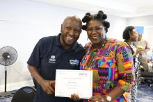 From left to right: Dr. Joseph Mwangi poses with Ms. Madeline Kayem after she received her certificate for completing the policy advocacy and media training