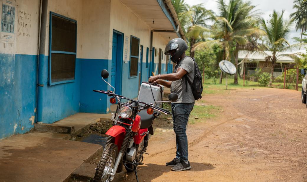 A healthcare worker on a motorbike at Carrysburg clinic to get a refill of vaccines to be taken to the communities.