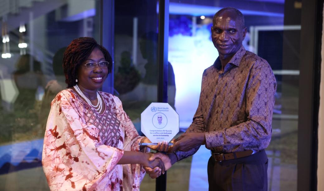 WHO Representative Malawi WR- Dr Neema Rusibamayila Kimambo hands over a token of honor to Mr Ishmael Nyasulu